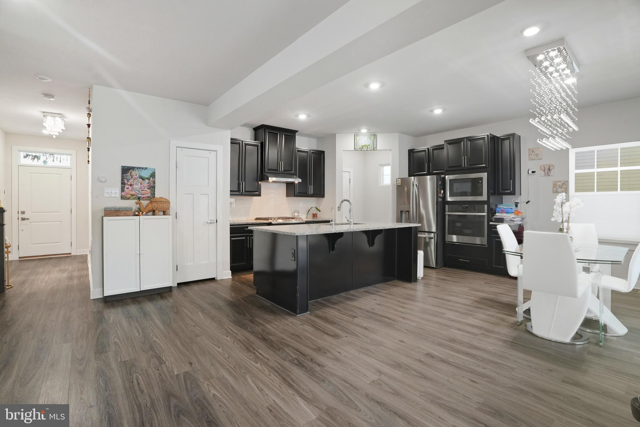 214 Pixie Moss Road Pottstown, PA 19464 - Photo 5 of 27 a large kitchen with stainless steel appliances kitchen island a large counter top and a refrigerator