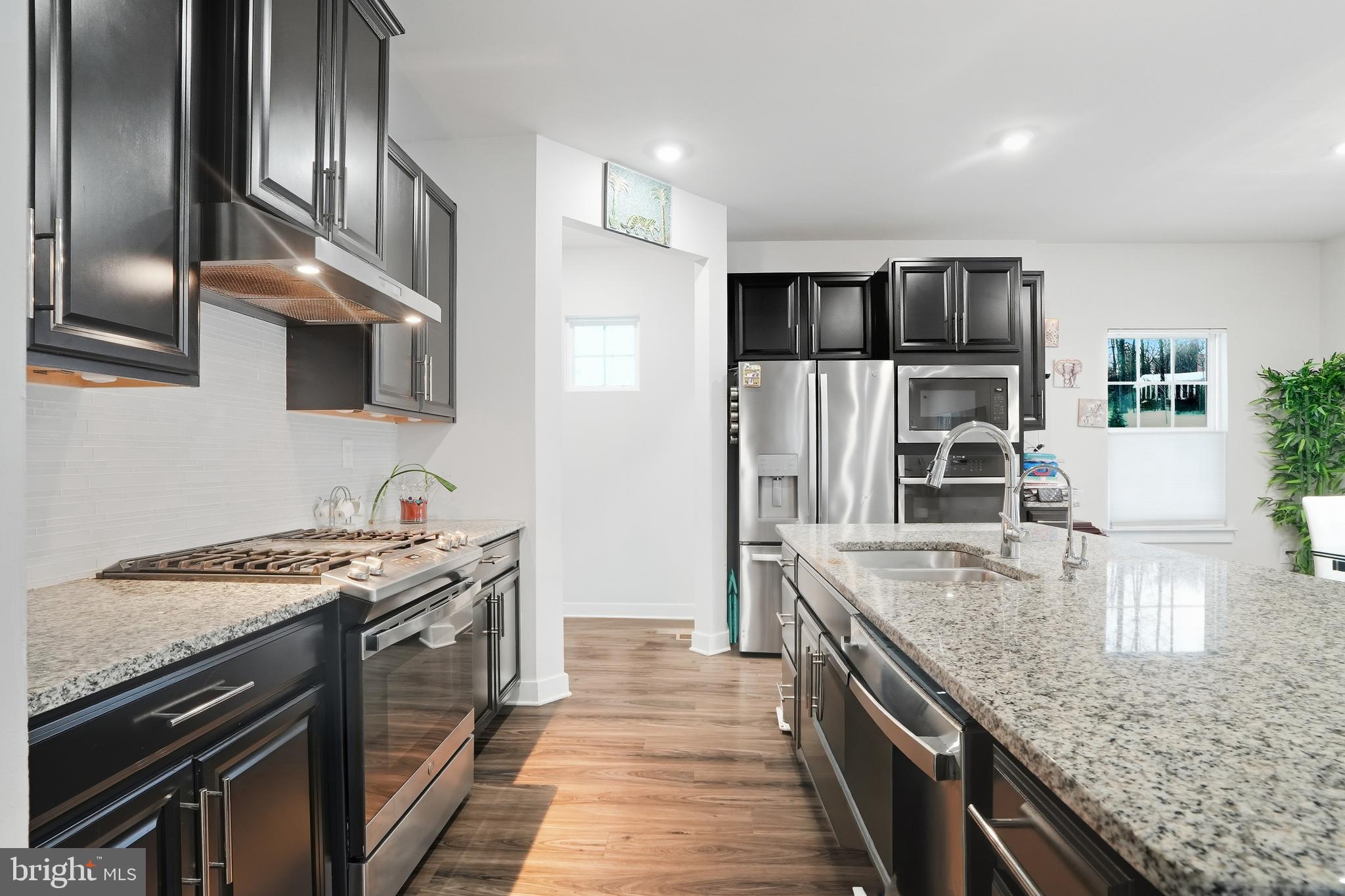214 Pixie Moss Road Pottstown, PA 19464 - Photo 6 of 27 a kitchen with stainless steel appliances granite countertop a stove a sink and a refrigerator