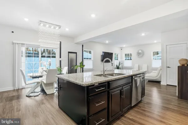 a kitchen with center island and wooden floor