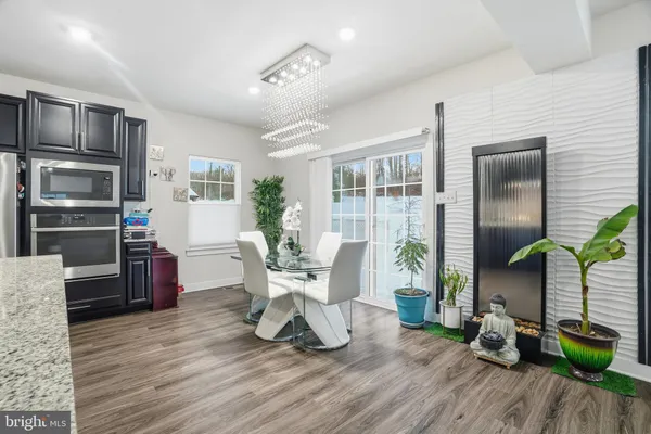 a living room with furniture a wooden floor and next to a window