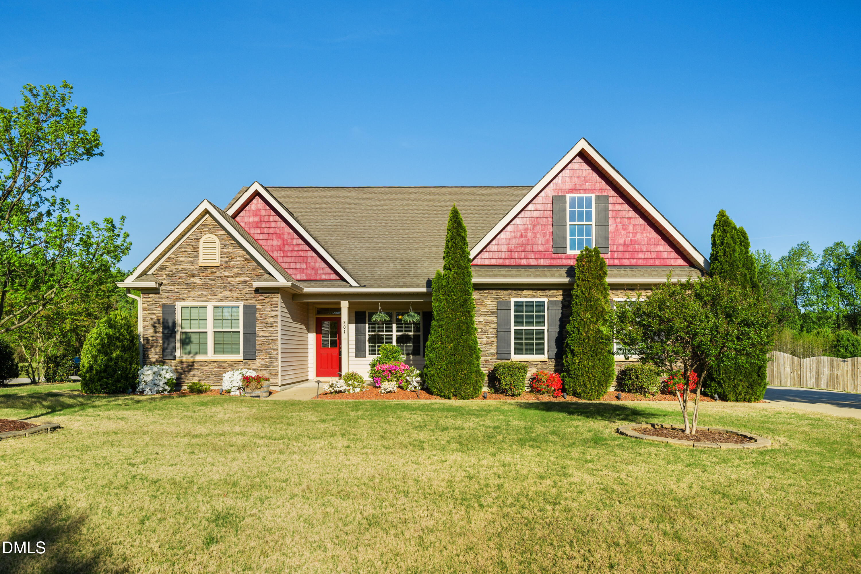a front view of house with yard and green space