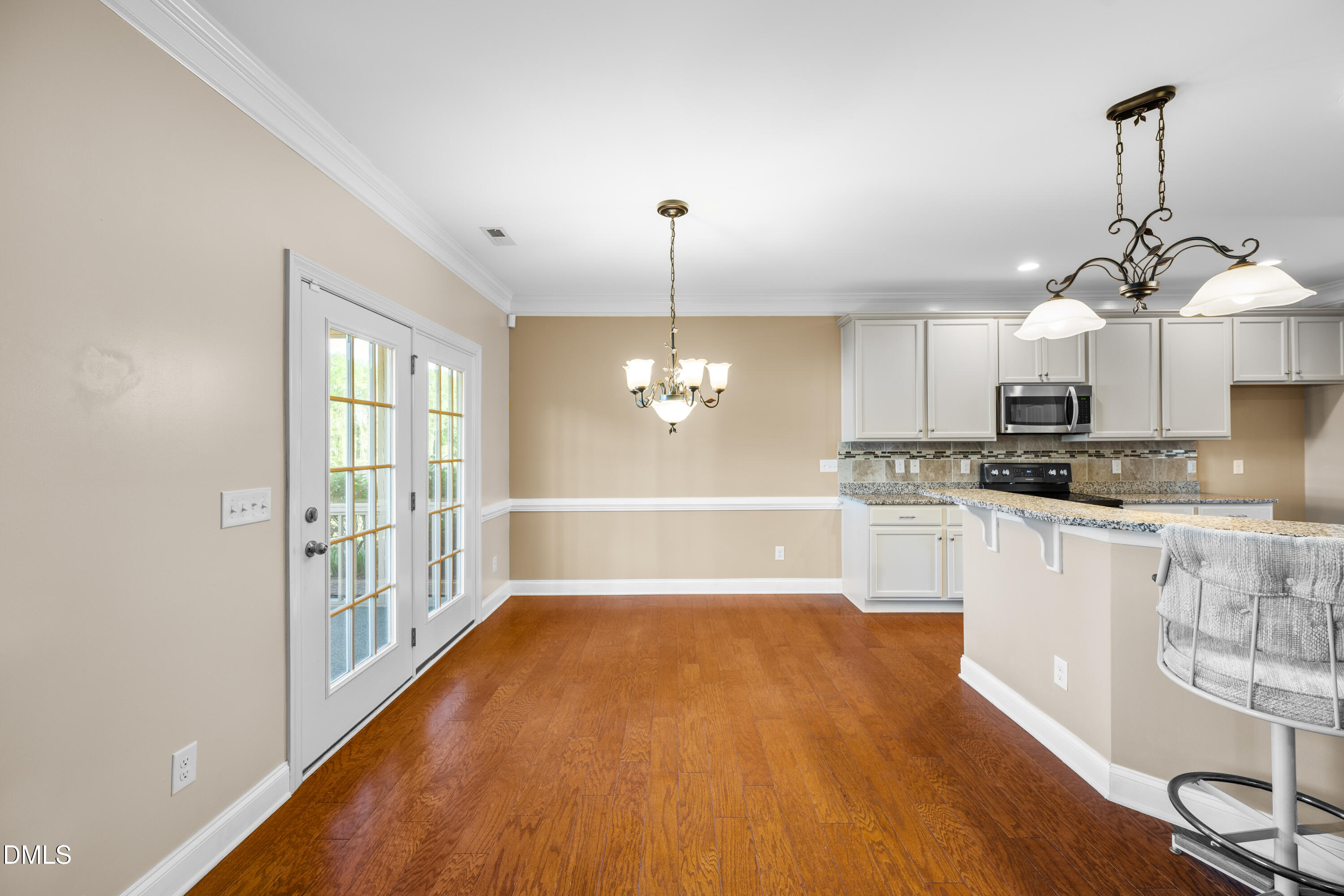 701 Spruce Meadows Lane Willow Spring, NC 27592 - Photo 10 of 54 a view of a kitchen with wooden floor and a window