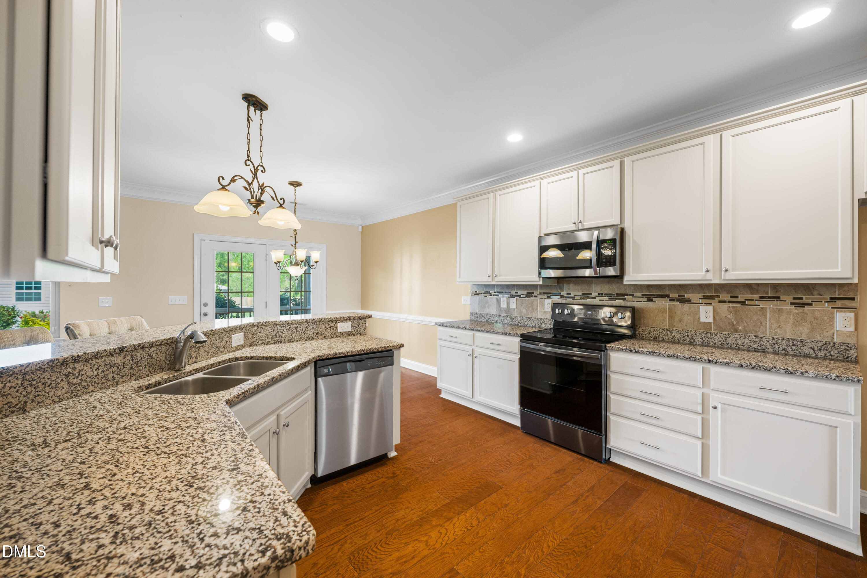 701 Spruce Meadows Lane Willow Spring, NC 27592 - Photo 13 of 54 a kitchen with stainless steel appliances granite countertop a sink stove and cabinets