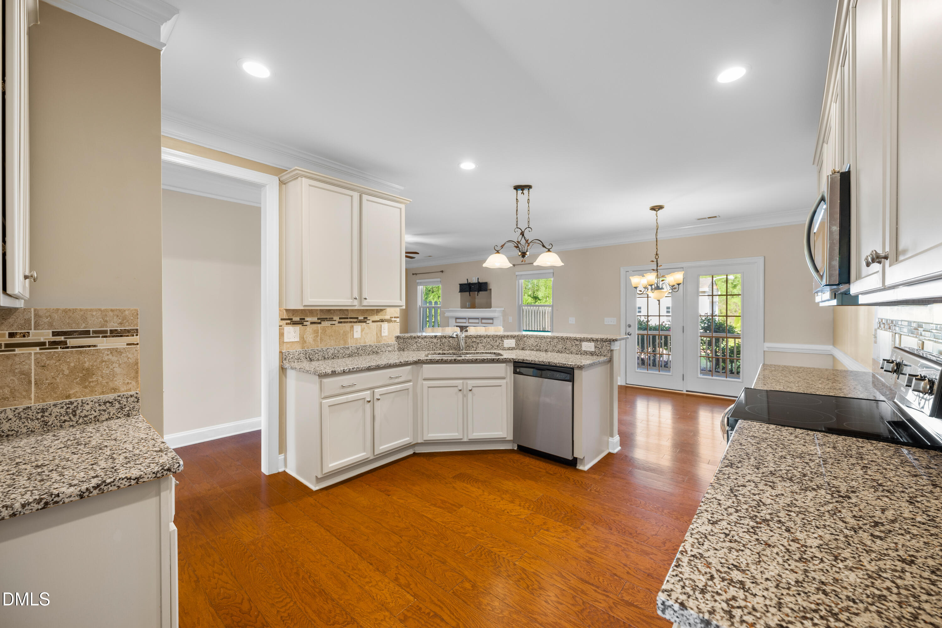 701 Spruce Meadows Lane Willow Spring, NC 27592 - Photo 14 of 54 a kitchen with stainless steel appliances granite countertop a refrigerator a sink dishwasher a stove and white cabinets with wooden floor