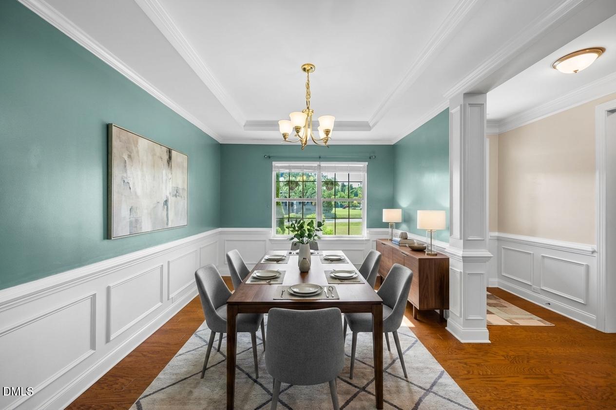 701 Spruce Meadows Lane Willow Spring, NC 27592 - Photo 17 of 54 a view of a dining room with furniture a chandelier and wooden floor