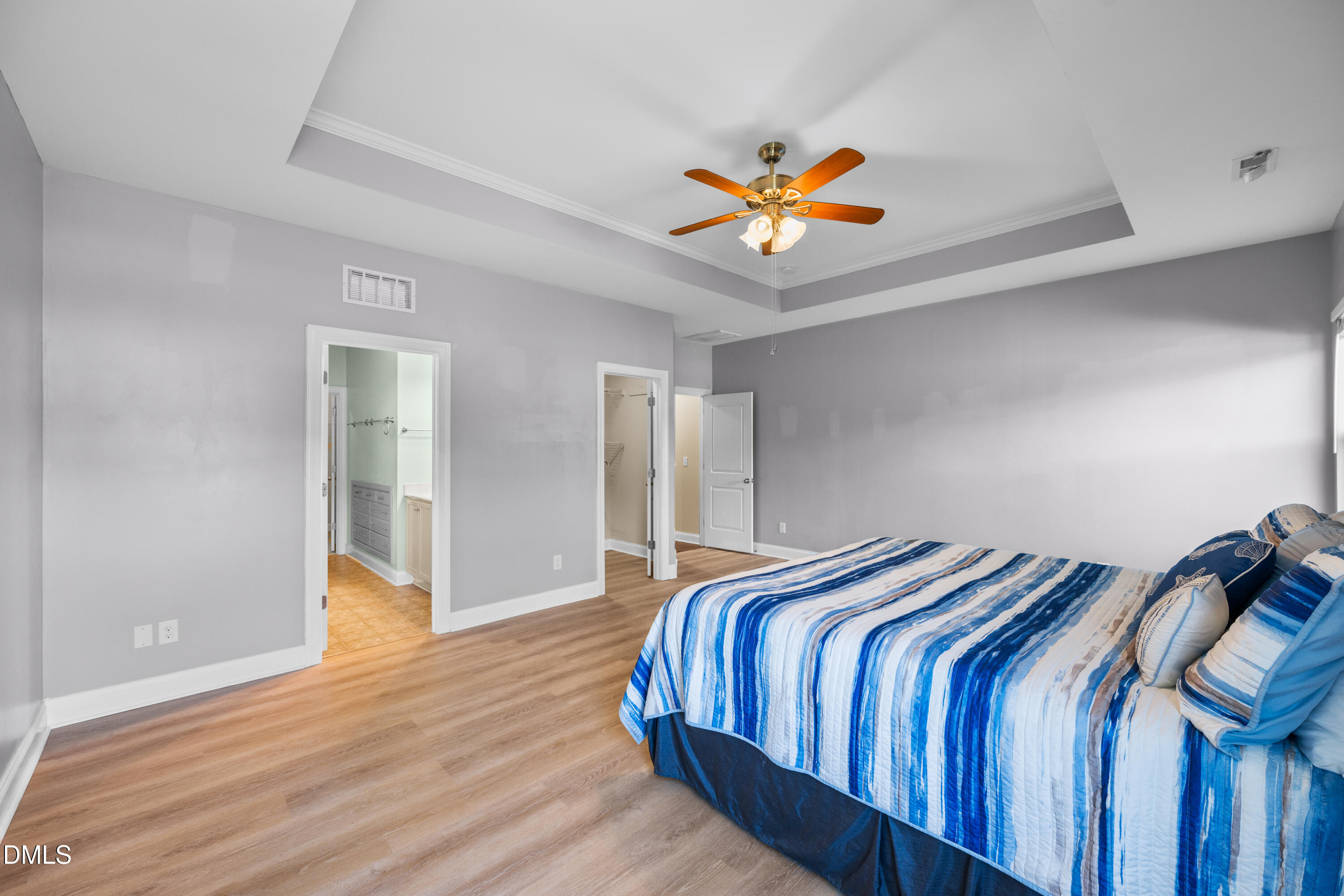 701 Spruce Meadows Lane Willow Spring, NC 27592 - Photo 20 of 54 a bedroom with a bed and a chandelier