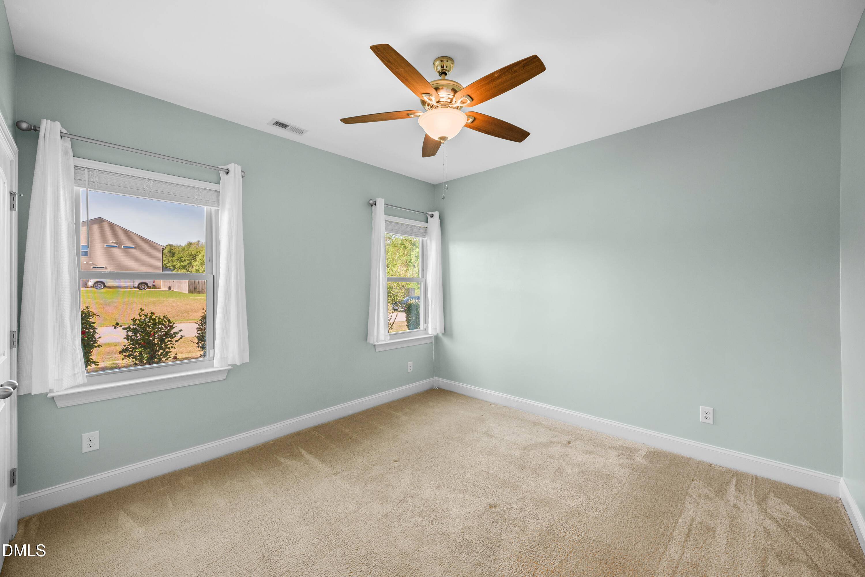 701 Spruce Meadows Lane Willow Spring, NC 27592 - Photo 27 of 54 an empty room with window and ceiling fan