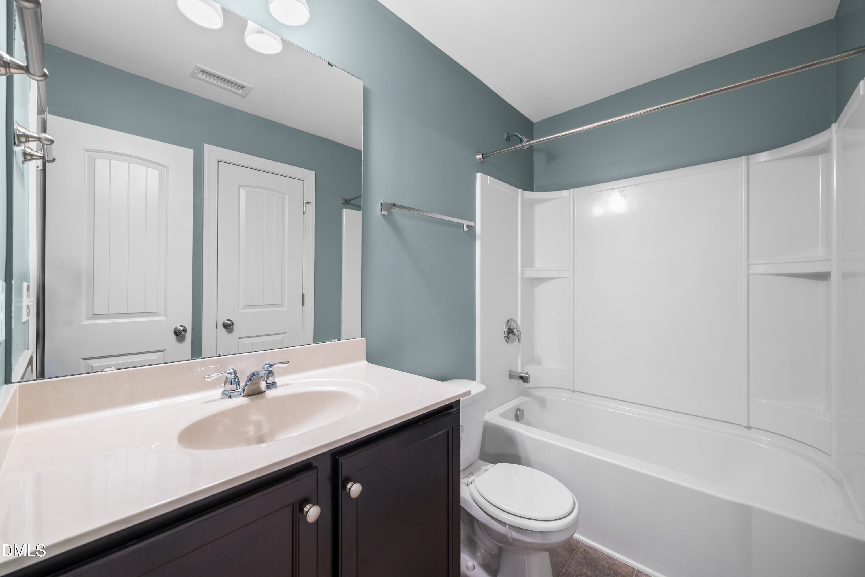 701 Spruce Meadows Lane Willow Spring, NC 27592 - Photo 33 of 54 a bathroom with a sink a toilet and a large mirror