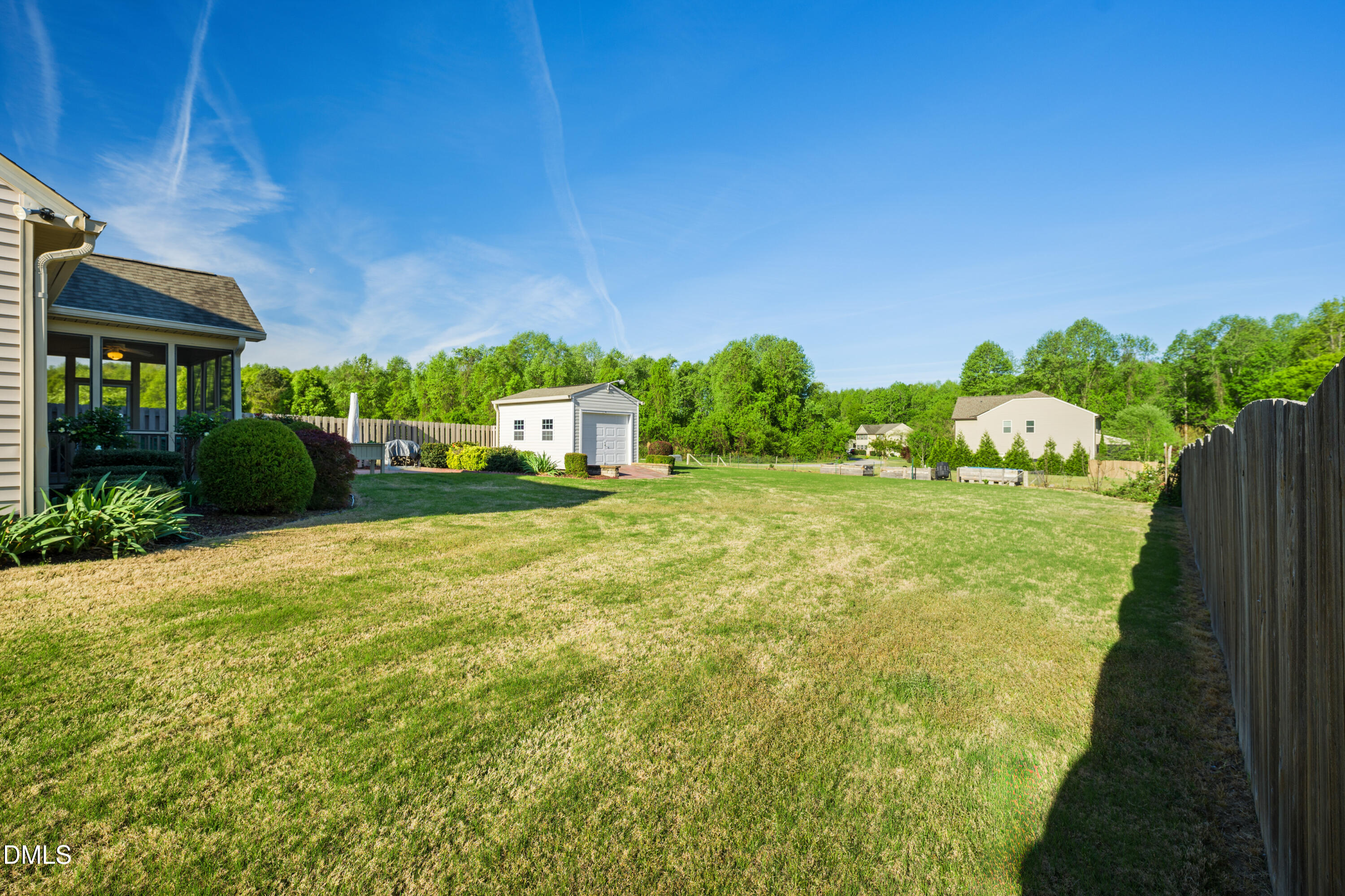 701 Spruce Meadows Lane Willow Spring, NC 27592 - Photo 38 of 54 a view of a garden with a house in the background