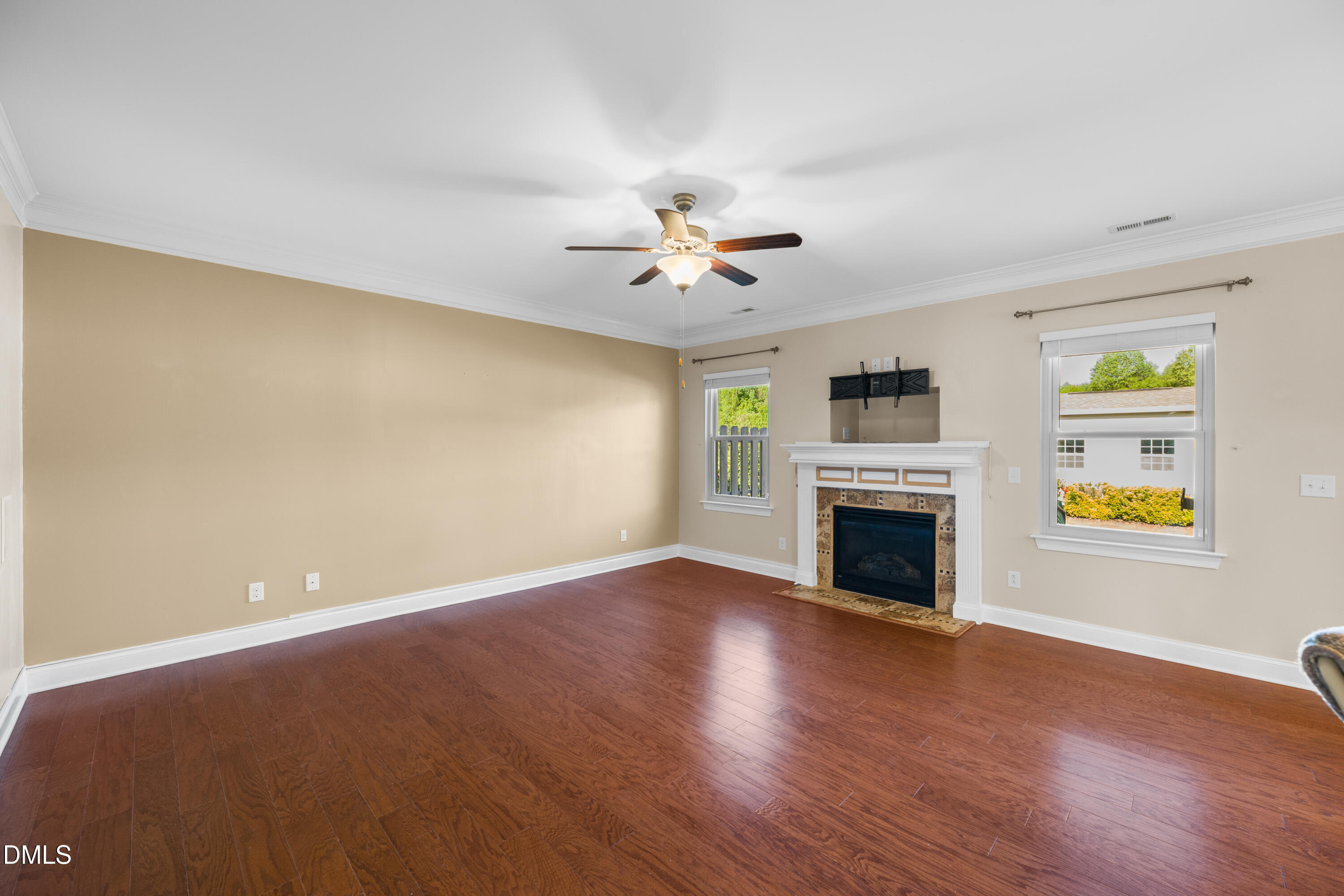 701 Spruce Meadows Lane Willow Spring, NC 27592 - Photo 6 of 54 wooden floor in an empty room with a window