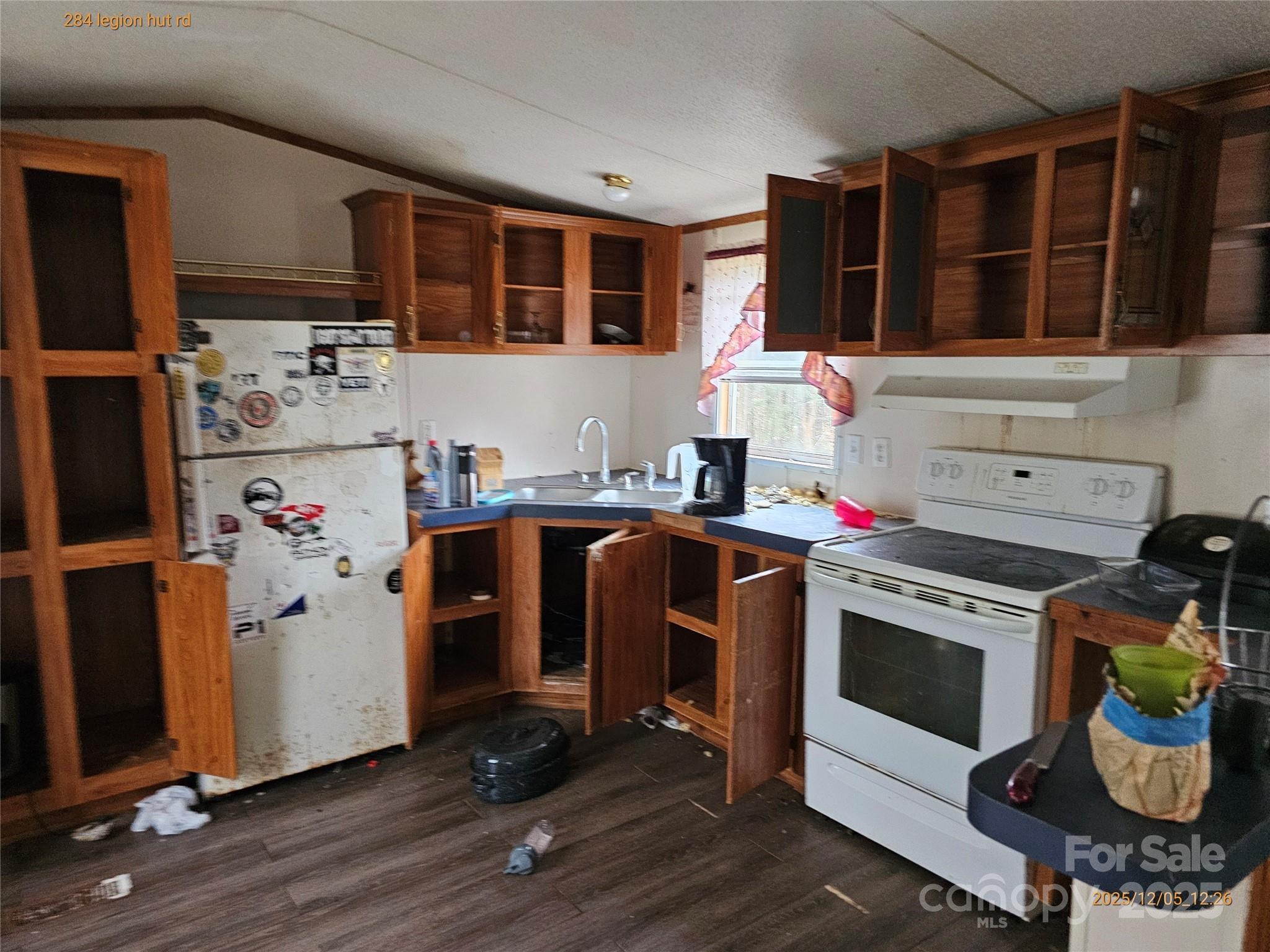 284 Legion Hut Road Mocksville, NC 27028 - Photo 2 of 16 a utility room with stainless steel appliances granite countertop a stove and a refrigerator