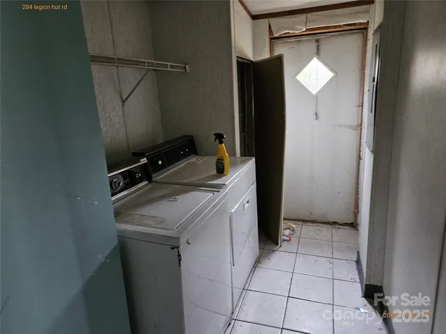 a utility room with cabinets washer and dryer