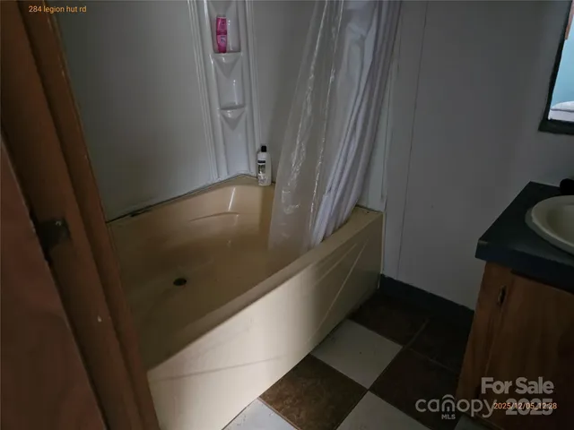 a bathroom with a bathtub and shower