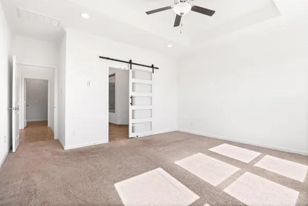 an empty room with closet and a ceiling fan