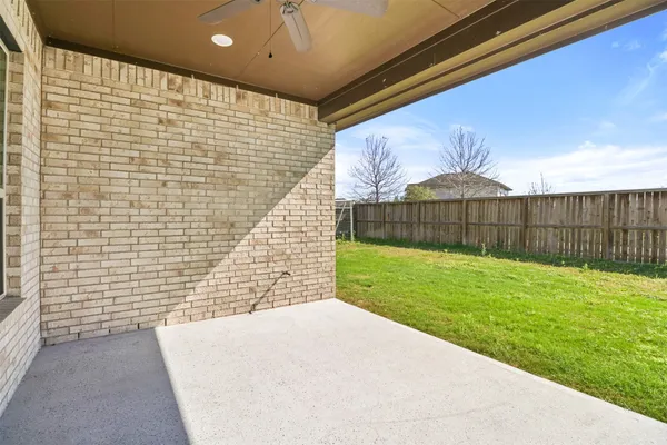 a view of backyard with wooden fence