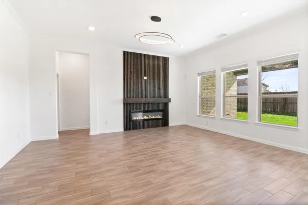 a view of an empty room with a window and bathroom view