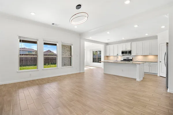 a view of kitchen with granite countertop cabinets and wooden floor