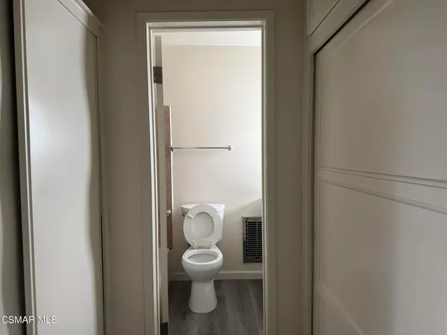 a white toilet sitting next to a shower