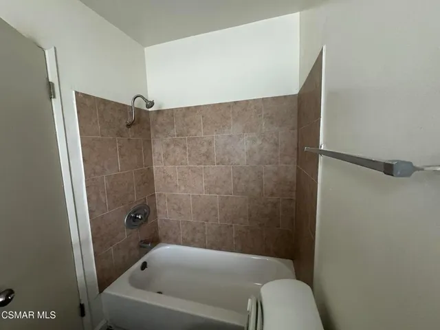 a bathroom with a bathtub and shower