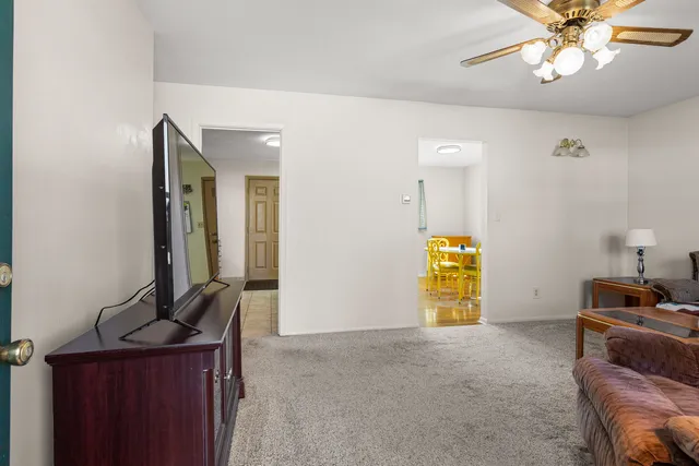a view of a livingroom with furniture and an empty room
