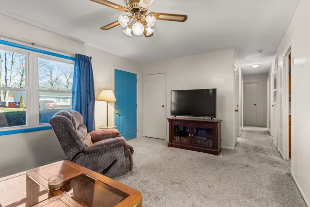 a living room with furniture and a flat screen tv