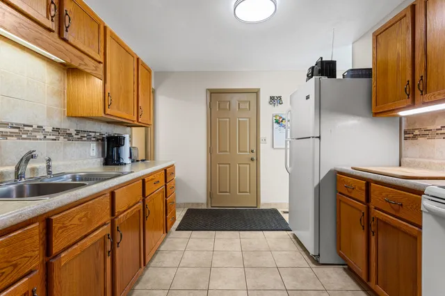 a kitchen with stainless steel appliances a refrigerator sink and cabinets