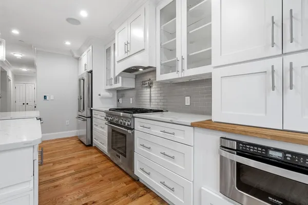 a kitchen with stainless steel appliances granite countertop a stove and a refrigerator