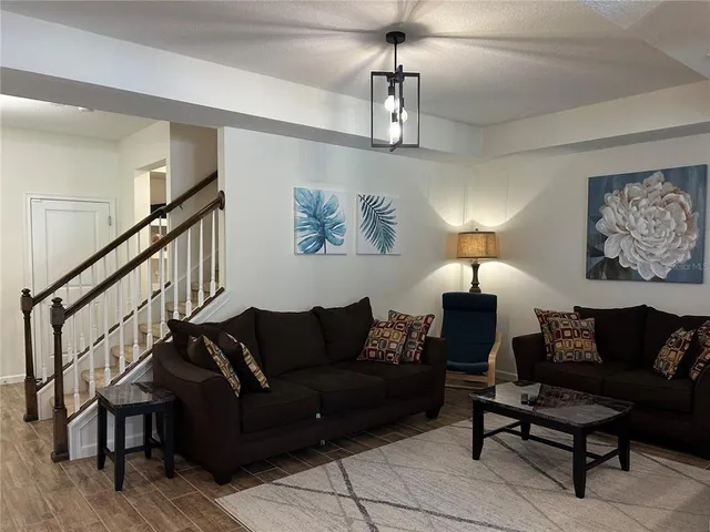 a living room with furniture and a lamp