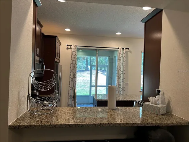 a living room with rug floor and a large window