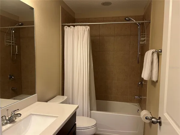 a bedroom with a bed and a night stand