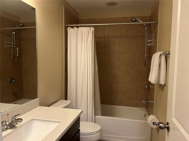 a bedroom with a bed and a night stand