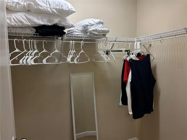 a view of hallway with closet and a window