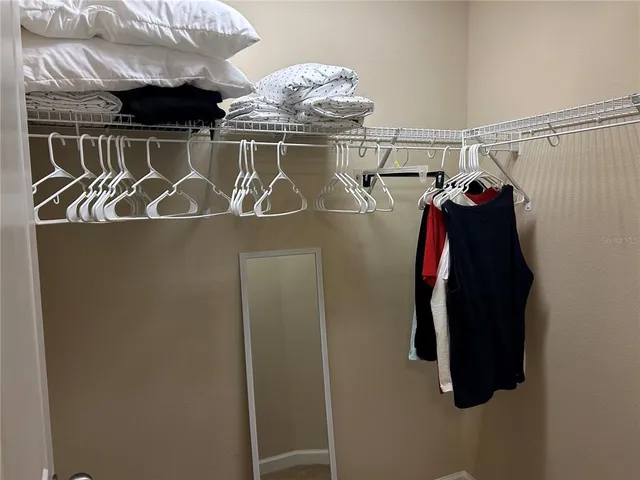 a view of hallway with closet and a window