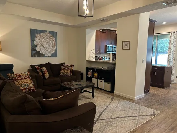 a living room with furniture and a chandelier
