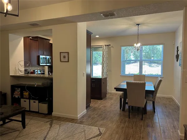 a dining room with furniture and window
