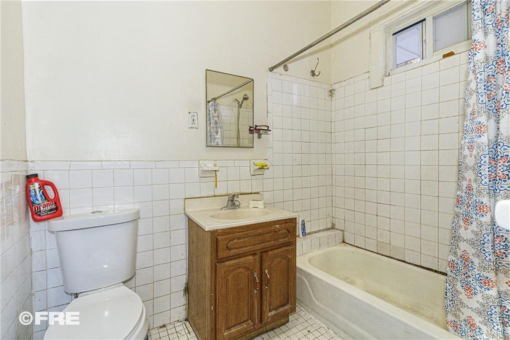 479 East 8th Street Brooklyn, NY 11218 - Photo 12 of 15 a bathroom with a sink a toilet and a bathtub