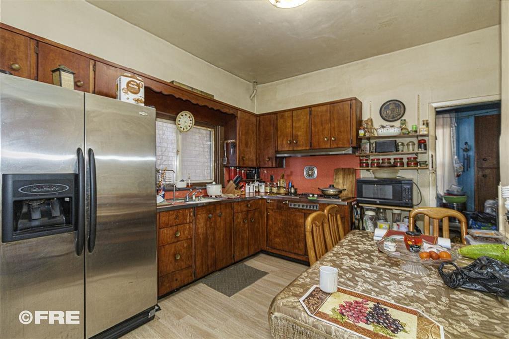 479 East 8th Street Brooklyn, NY 11218 - Photo 6 of 15 a kitchen with stainless steel appliances granite countertop a refrigerator a stove and a sink