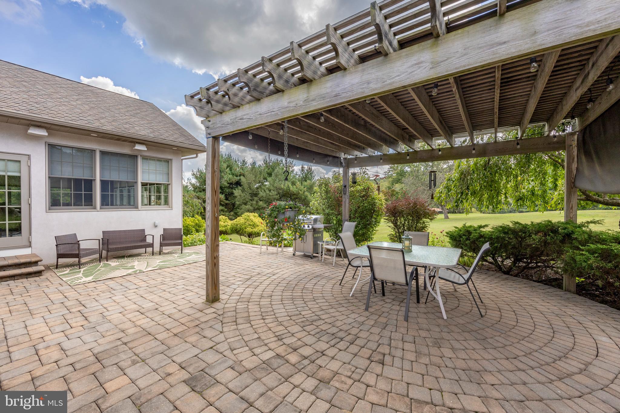 1720 St Peters Road Pottstown, PA 19465 - Photo 50 of 65 a view of a patio with table and chairs next to a yard