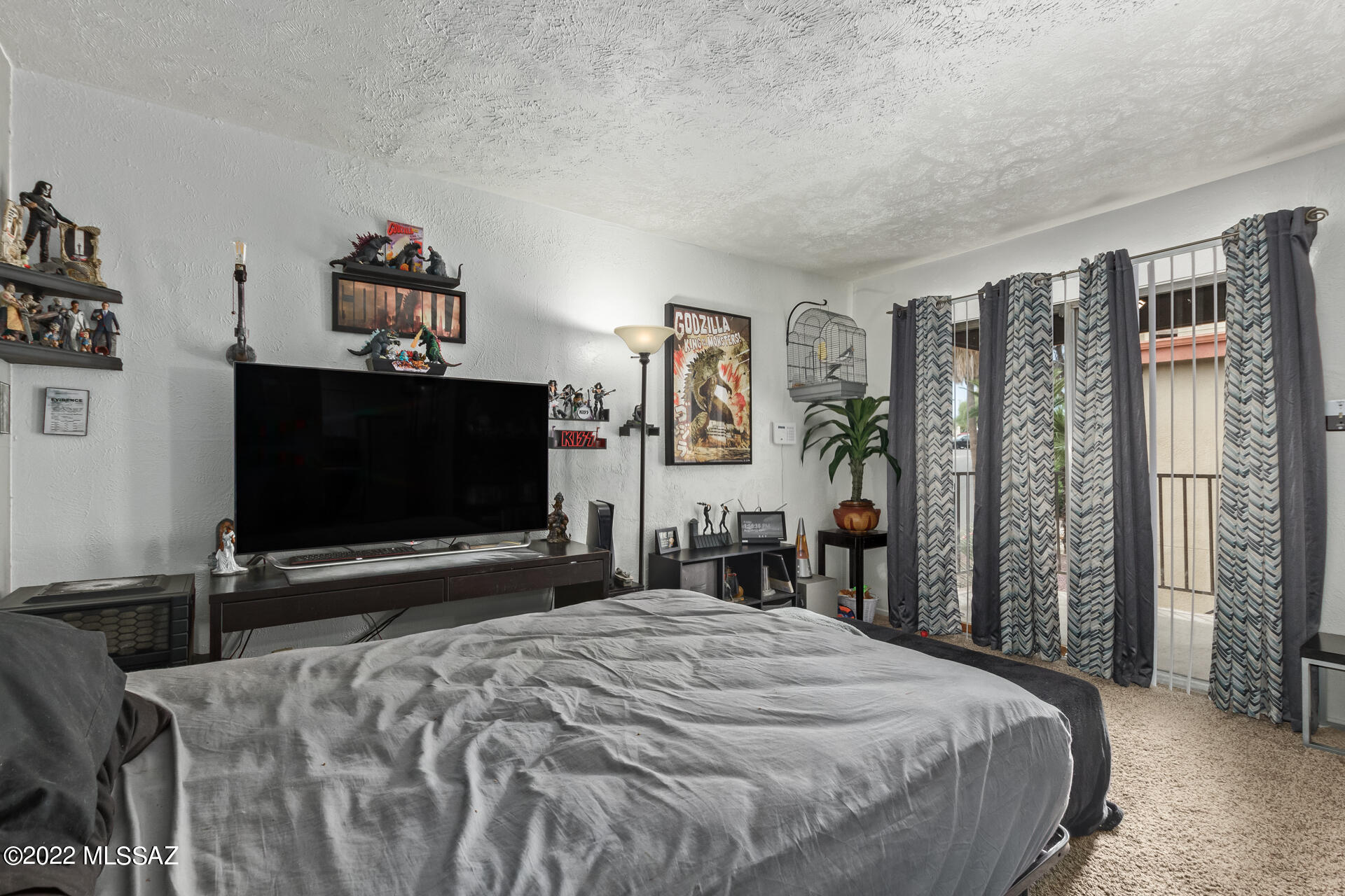 1620 North Wilmot Road, Unit D273 Tucson, AZ 85712 - Photo 6 of 15 a bedroom with a bed and a flat screen tv