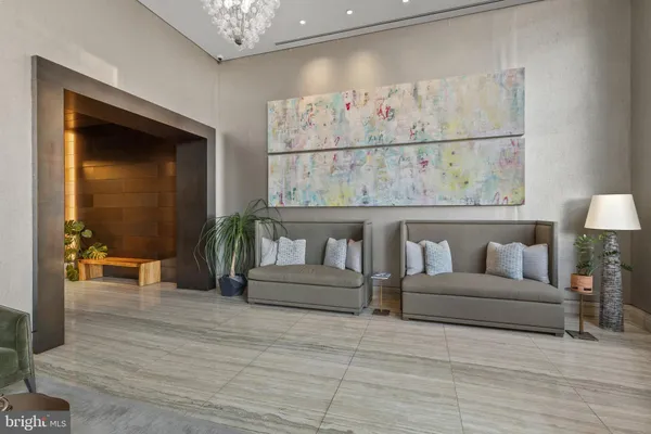 a living room with furniture and a painting