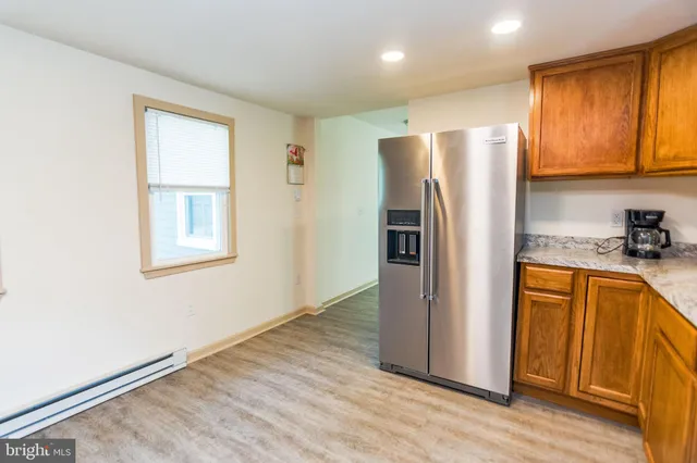 a metallic refrigerator freezer sitting in a kitchen