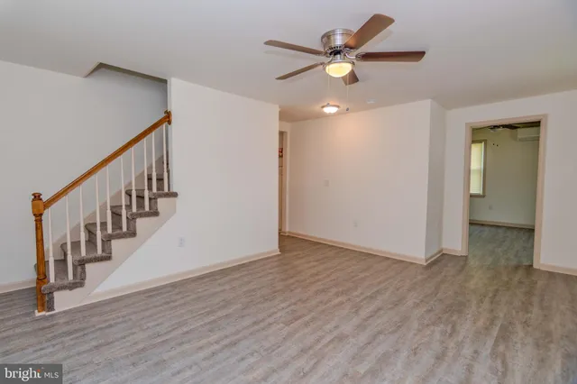 a view of an empty room with wooden floor
