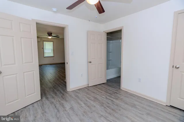 an empty room with wooden floor and closet