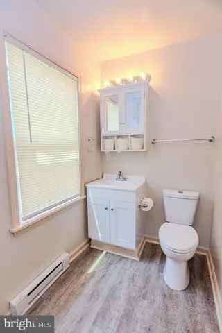a bathroom with a toilet sink and a mirror