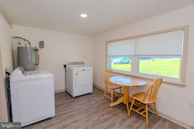 a view of a dining room with furniture and a window