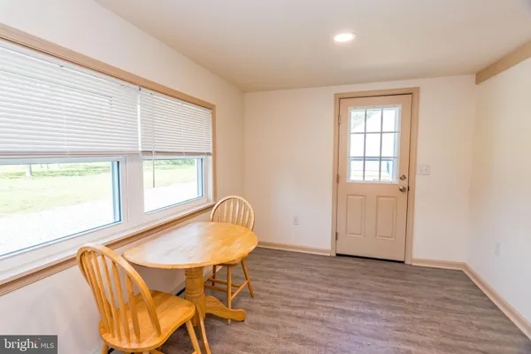 a view of a dining room with furniture and window