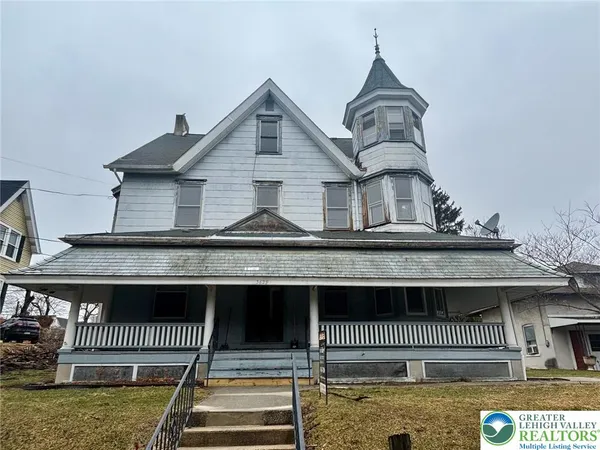 a front view of a house with a fence