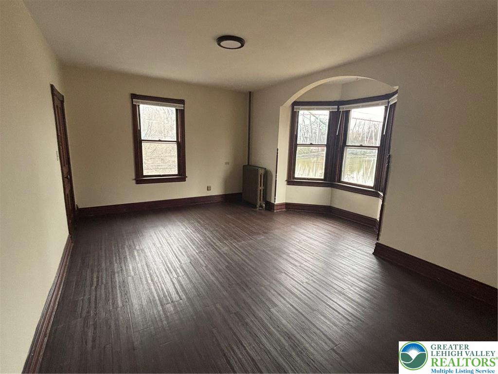3629 Dorney Road Allentown, PA 18104 - Photo 2 of 8 a view of an empty room with wooden floor and a window