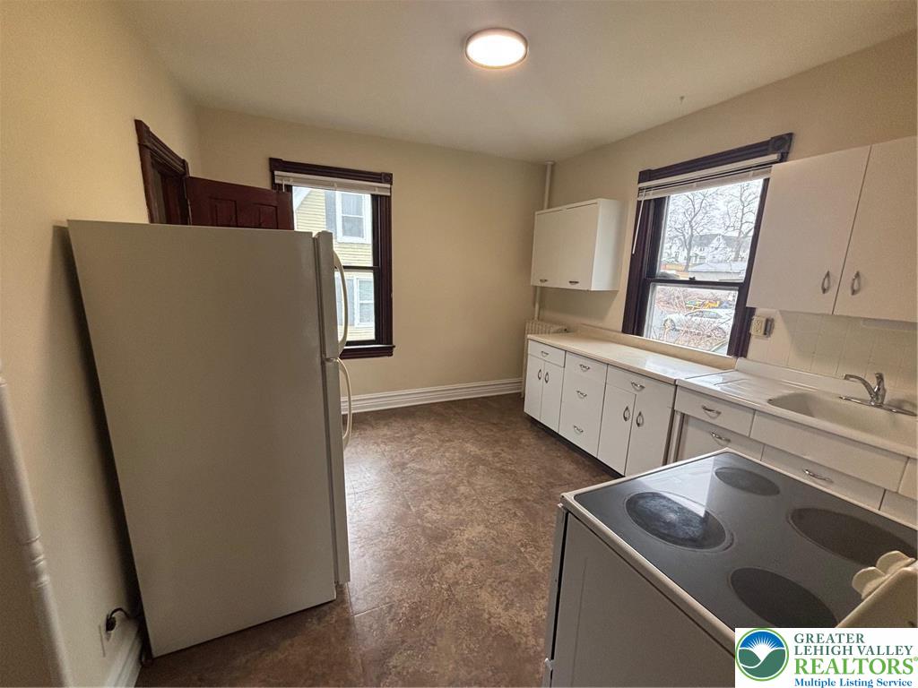3629 Dorney Road Allentown, PA 18104 - Photo 3 of 8 a kitchen with stainless steel appliances granite countertop a sink stove and cabinets
