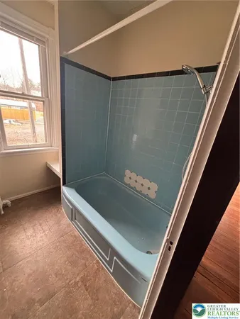 a view of bathroom with bathtub and shower